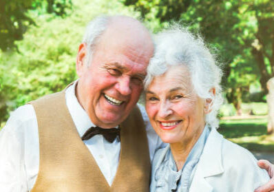 Happy senior couple love story. Old couple is walking in the green park. Grandmother and grandfather laughing. Elderly people lifestyle. Together Pensioners.