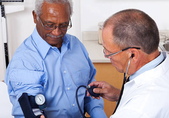 XXXL.  Patient getting his blood pressure taken in a doctor's office.