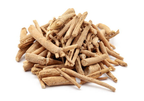 A pile of Dry Organic Ashwagandha (Withania somnifera) roots, isolated on a white background. Front view